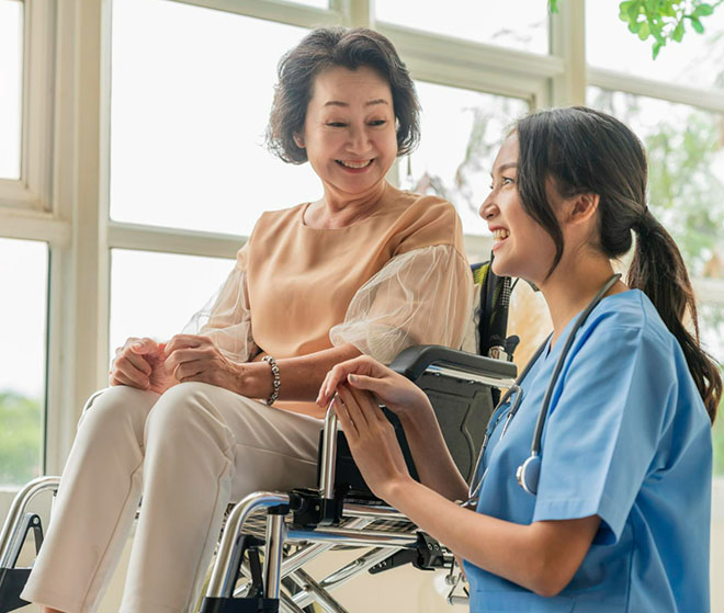 AG - nurse talking to a patient on a wheelchair